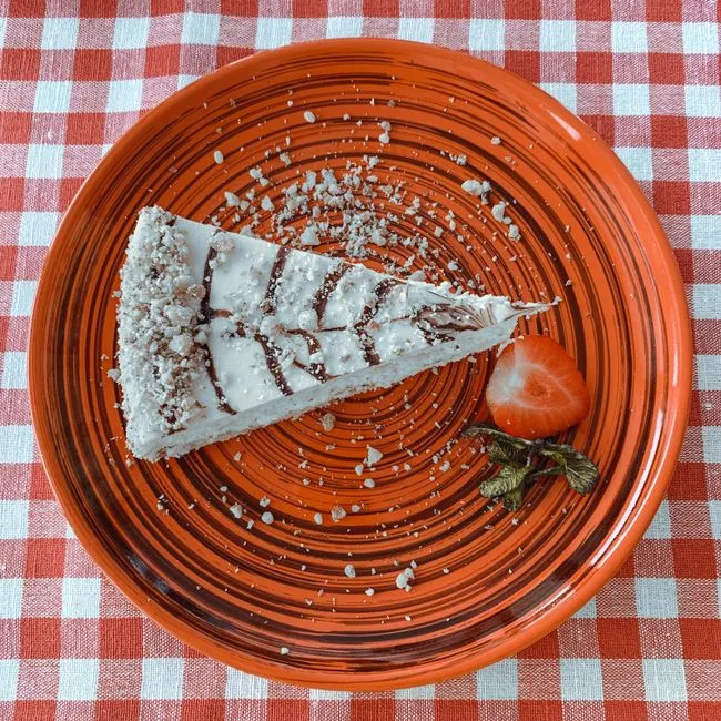 A slice of homemade cake on a plate at Paradise Cafe